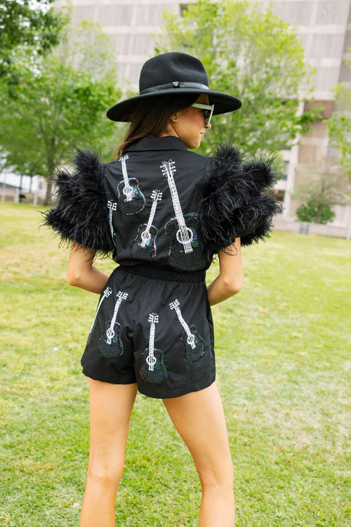 queen of sparkles black guitar feather sleeve romper