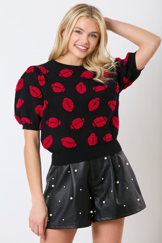 Peach Love California Black sweater knit short sleeve top with red fuzzy footballs all over