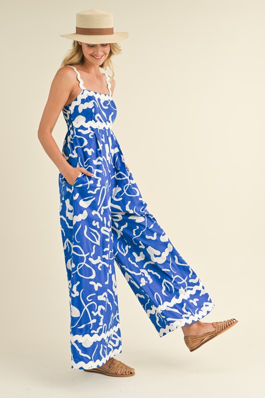 &merci Blue and white abstract print wide leg jumpsuit with scalloped ric rac trim