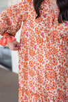 rust orange printed long sleeve midi dress