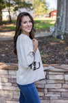 cream black trim bow sleeve top