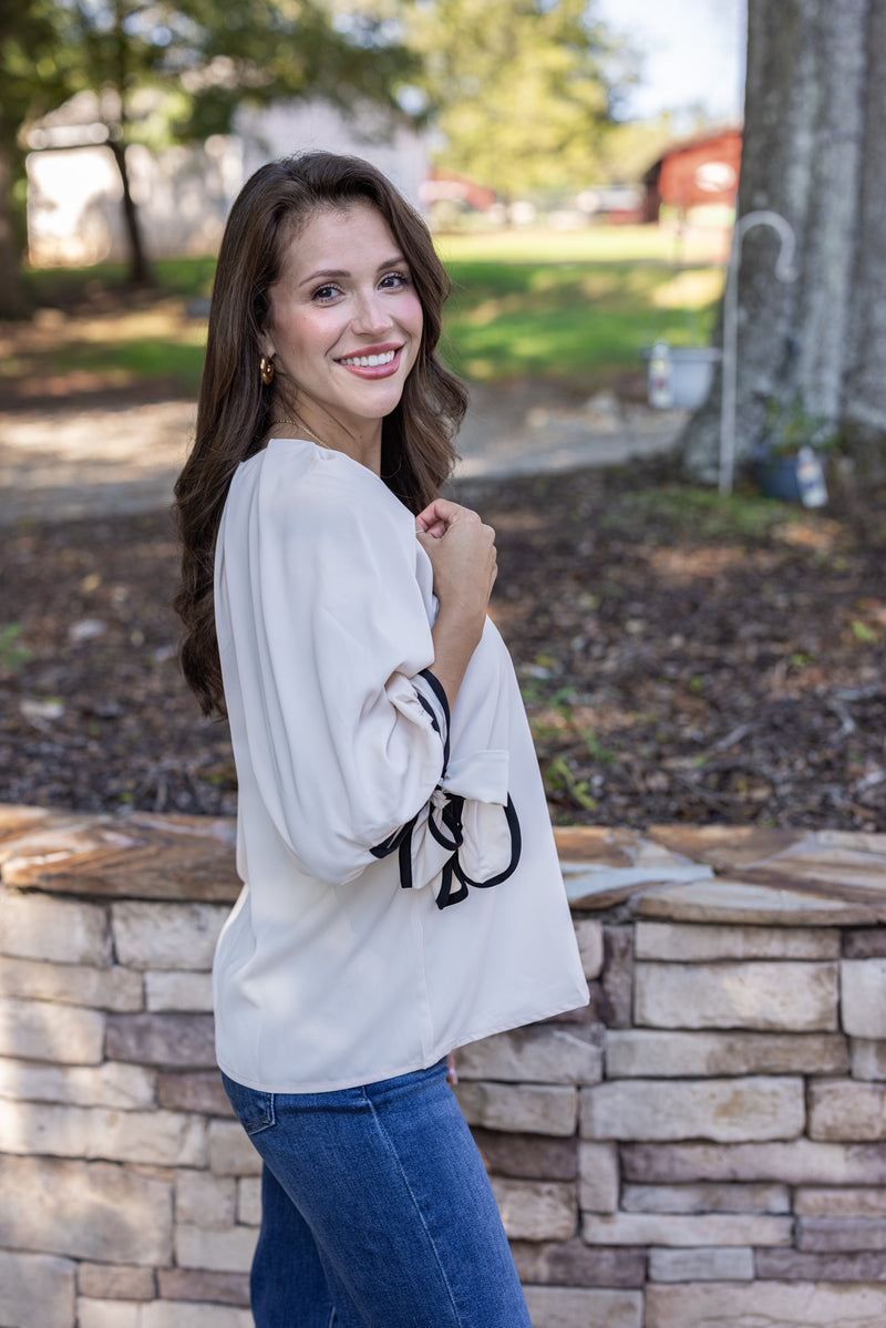 cream black trim bow sleeve top