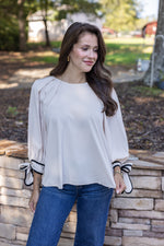 cream black trim bow sleeve top