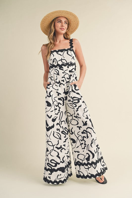 &merci White and black abstract print wide leg jumpsuit with scalloped ric rac trim