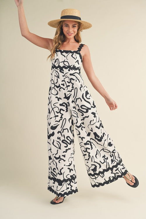 &merci White and black abstract print wide leg jumpsuit with scalloped ric rac trim